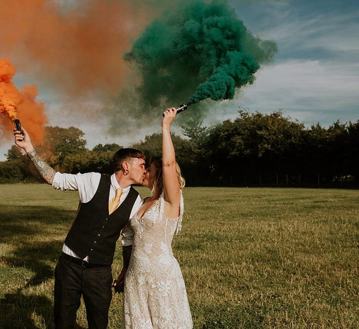 Bright wedding decor with colourful smoke bombs and canary yellow bridesmaid dresses