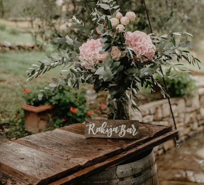 Wooden Bar Sign and Pink Hydrangeas and Eucalyptus Wedding Flower Decor