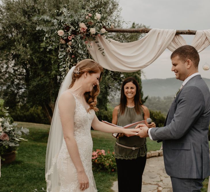 Bride and Groom Exchanging Vows at their Outdoor Wedding Ceremony