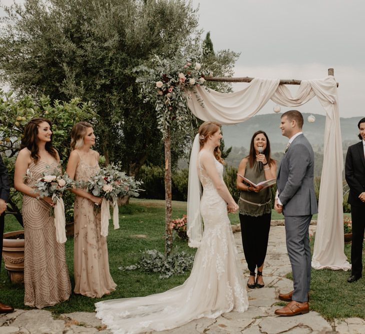 Bride and Groom Exchanging Vows at their Outdoor Wedding Ceremony