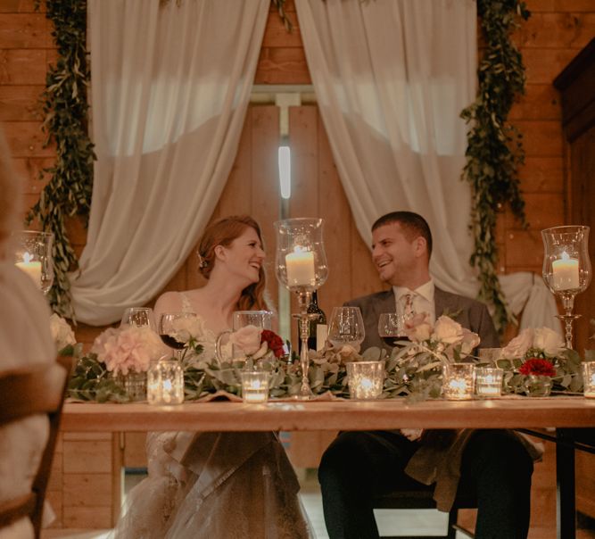 Sweetheart Table with Candle Light and Drapes Backdrop