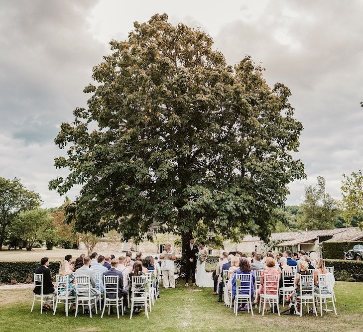 Guests at wedding ceremony in Chateau Rigaud gardens