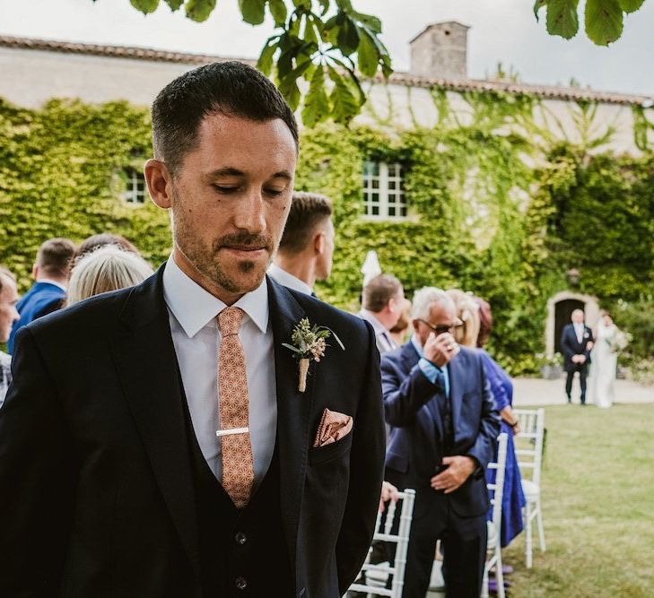 Groom waits for bride at the altar