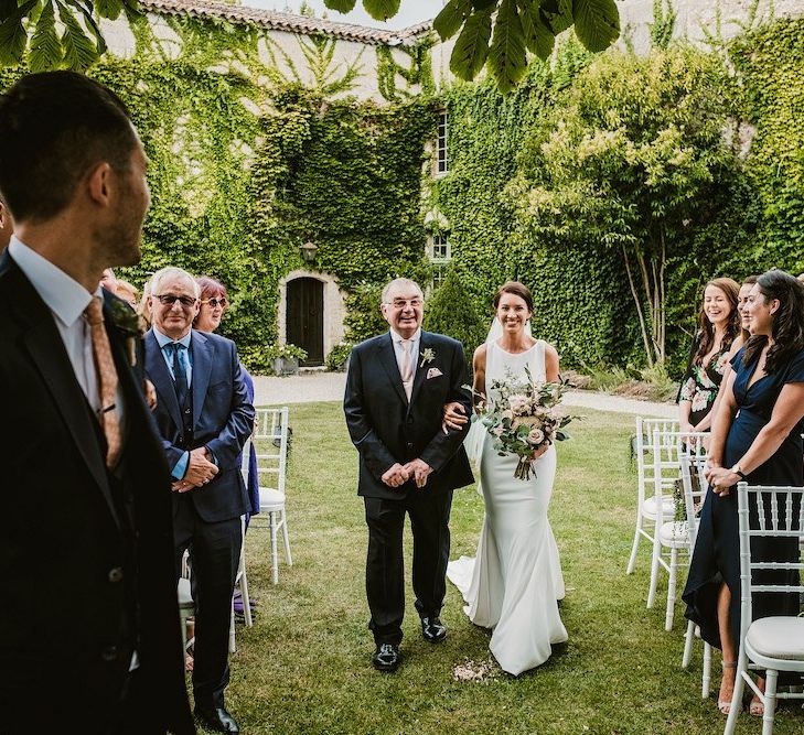 Bride walks down the aisle at Chateau Rigaud