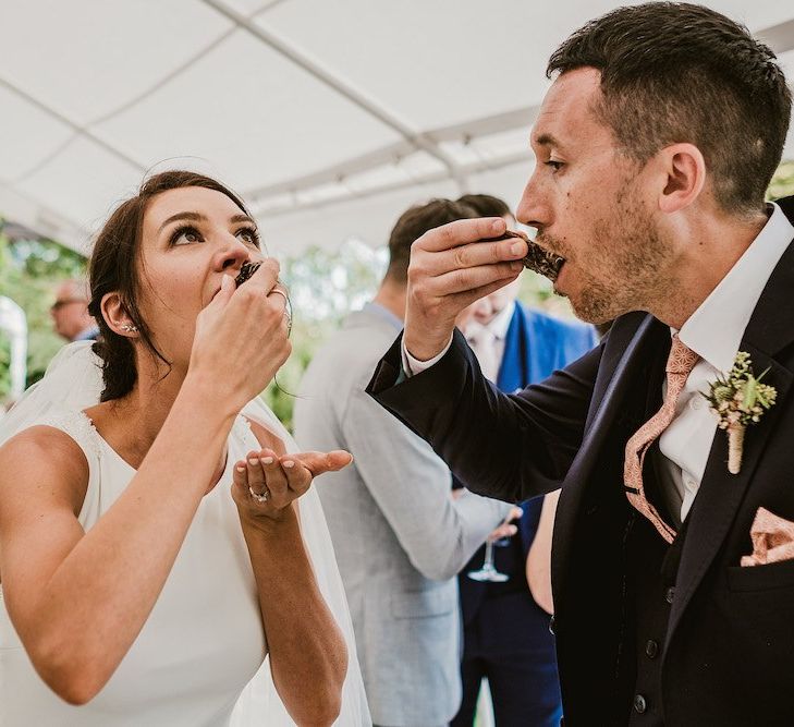 Bride and groom eat oysters at French wedding