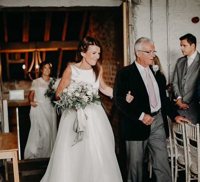 Ceremony bridal entrance in satin bodice and tulle skirt wedding dress