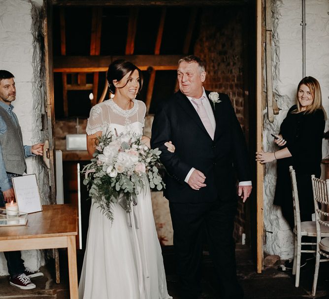 Ceremony bridal entrance in chiffon wedding dress with lace jacket