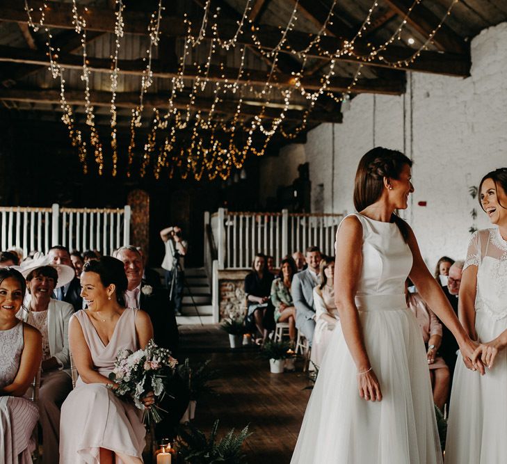 Lesbian wedding at Askham Hall with fairy light ceiling decor