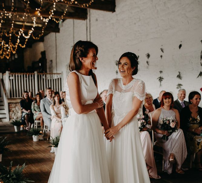 Same sex wedding with brides in chiffon and lace and satin and tulle wedding dresses