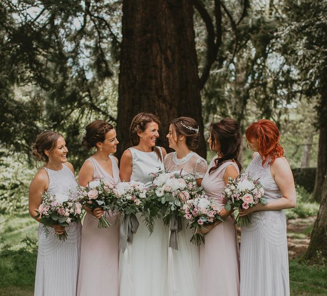 Bridal party portrait with bridesmaids in pastel high street dresses