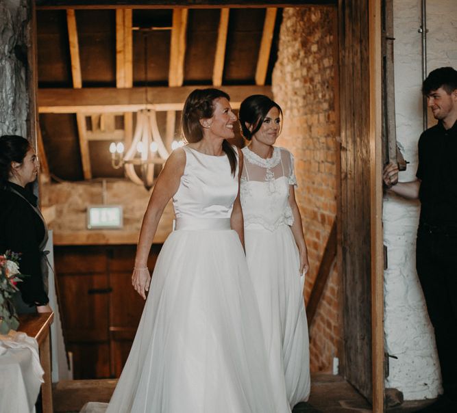 Two brides entering the reception at Askham Hall