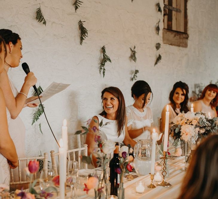 Best girl wedding speech with fern covered wall