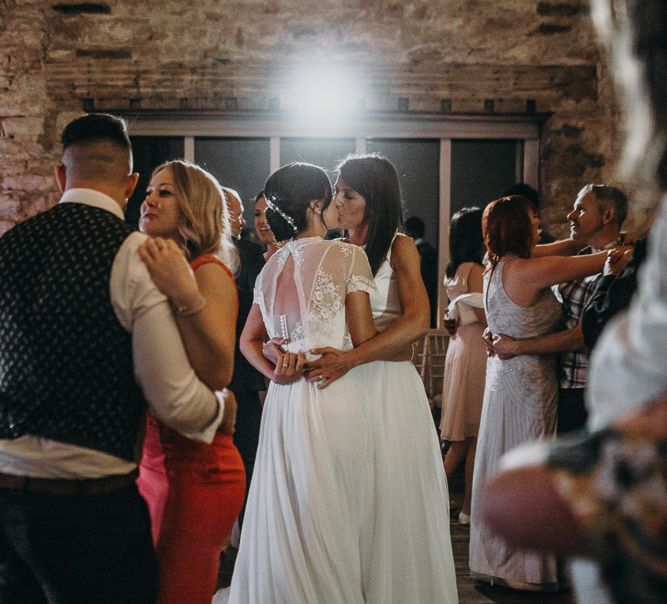 two brides kissing at their same sex wedding