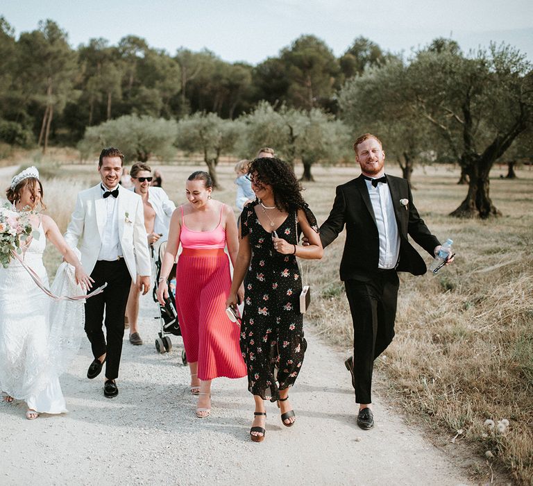 Guests Join Bride and Groom On Way To Outdoor Reception