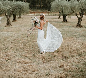 Bride In Low Back Lace Dress With Feather Headdress With Peony Bouquet