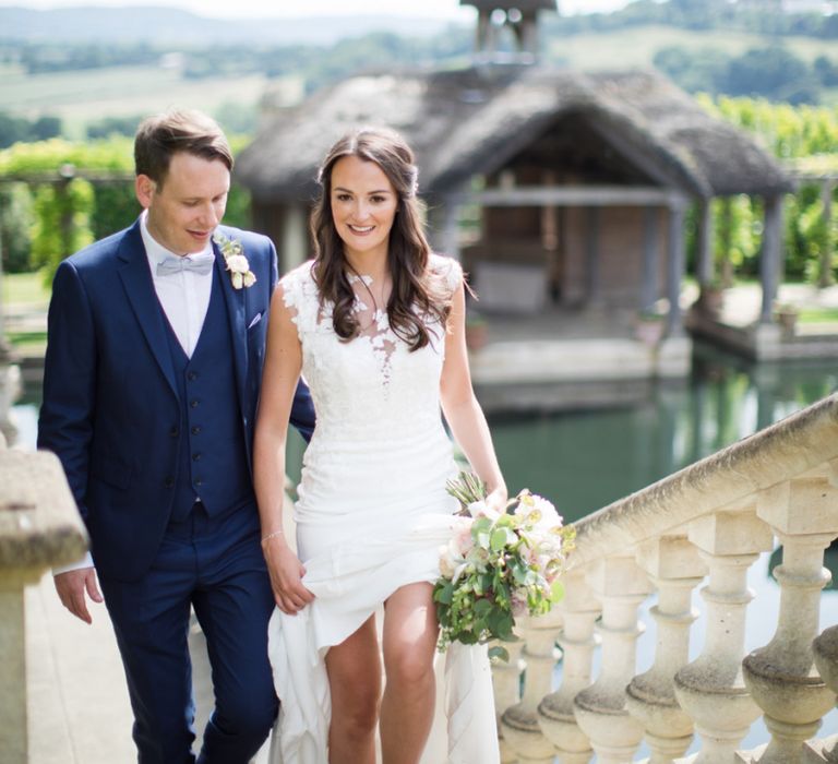 Bride and Groom Walking Up The Steps of The Lost Orangery