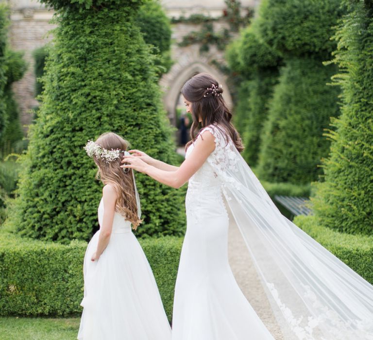 Bride in Lace Wedding Dress and Cape with Flower Girl