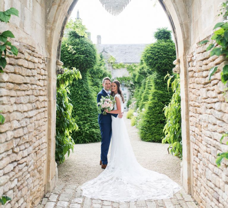 Bride and Groom Portrait Under The Crystal Chandelier at The Lost Orangery