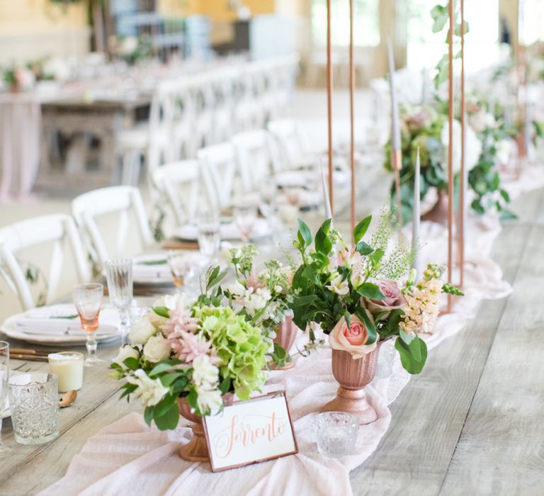 Long Tables with Pink Table Runner and Tall Copper Floral Displays