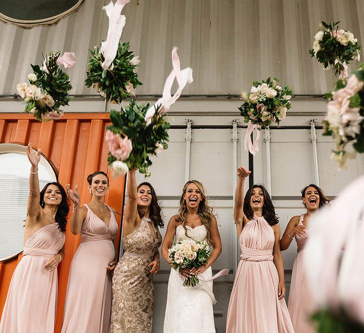 Bride In Suzanne Neville And Bridesmaids In Pink Multiway Dresses // London Wedding Venue For 300 People Trinity Buoy Wharf With Bride In Suzanne Neville And Images From Paul Joseph Photography Film This Modern Revelry