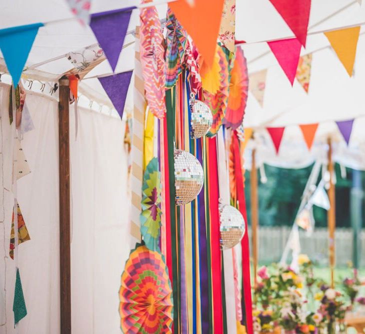 Bright ribbon homemade bunting and glitter ball decoration at marquee celebration