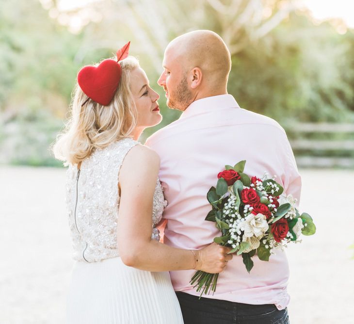 Beautiful two piece gown with pleated midi wedding skirt and bright homemade paper wedding bouquet