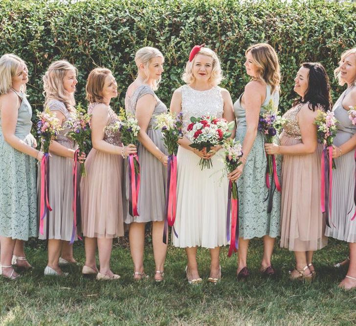 Bride wearing midi wedding skirt and bridesmaids with midi dresses in nude and duck egg