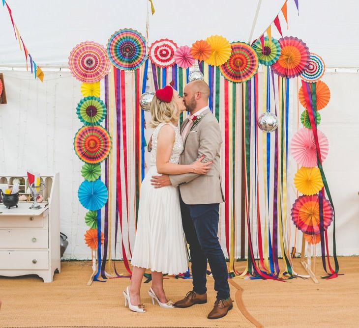 Bride and groom say 'I do' with bright ribbon decor and paper lantern decoration