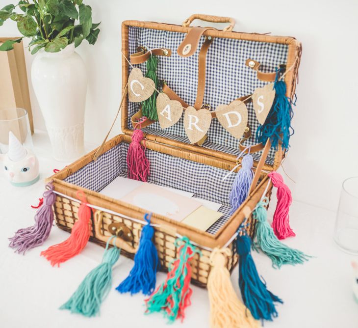 Homemade colourful tassel decoration for personalised card box at fun reception