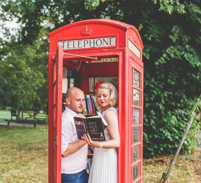 Bride and groom enjoy a moment together for a fun shoot inside telephone box