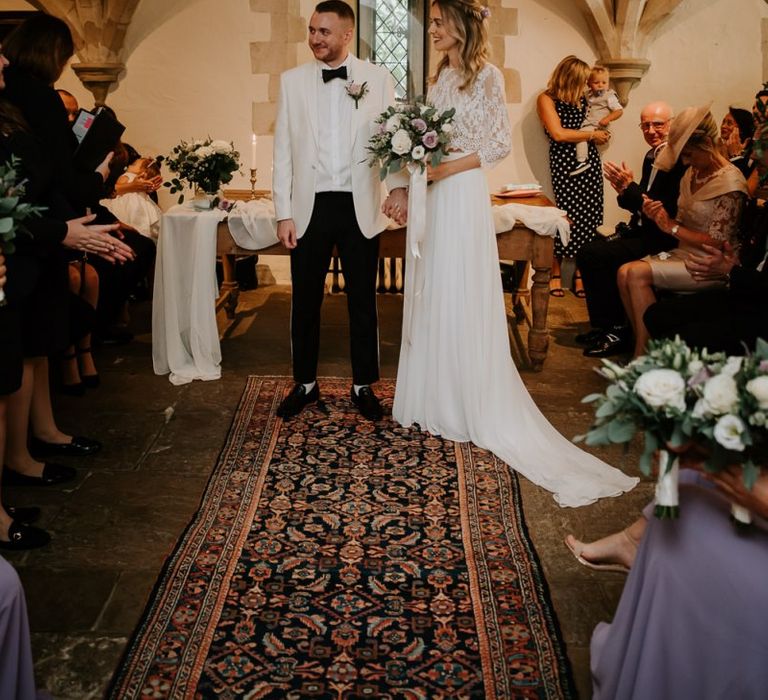 Bride and Groom Standing at the Altar in Nettlestead Place in Kent