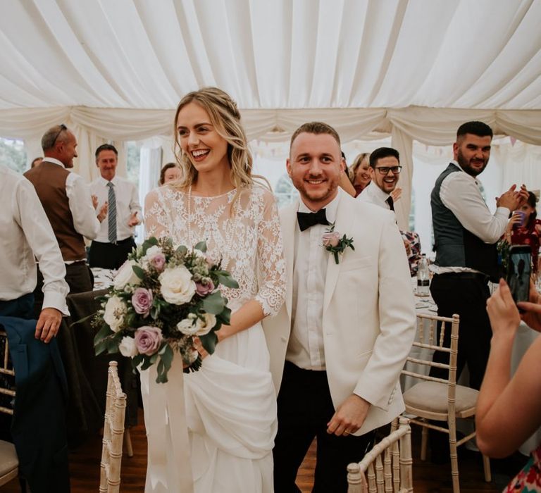 Bride in Separates and Groom in White Dinner Jacket Entering the Marquee Wedding Reception