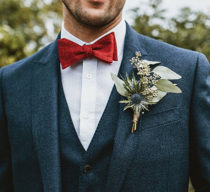 Groom in Blue Three-Piece Suit with Red Bow Tie