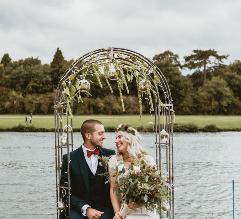 Bride and Groom Sat in Pergola