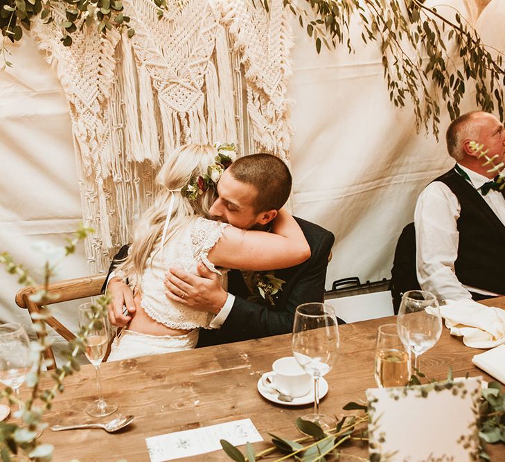 Bride and Groom Embrace During Speeches