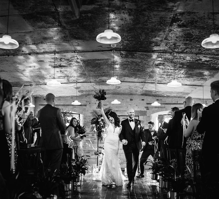 Bride in Martina Liana Lace Wedding Dress and Groom in Tom Ford Suit Walking Up The Aisle as Husband and Wife