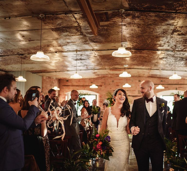 Bride in Martina Liana Lace Wedding Dress and Groom in Tom Ford Suit Walking up The West Mill Wedding Venue Aisle