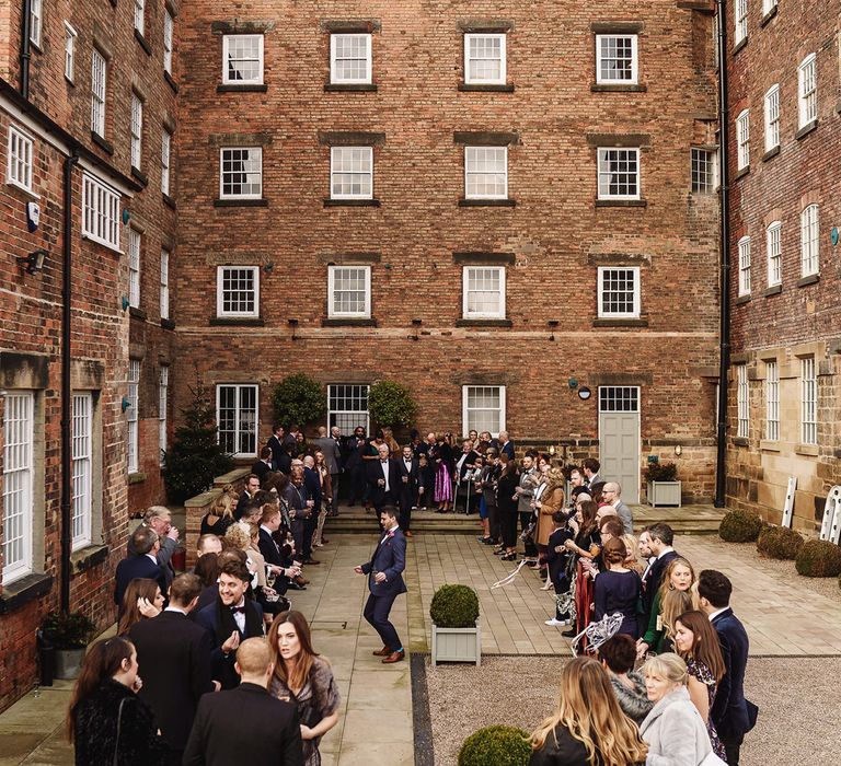 Wedding Guests Gathering Outside The West Mill Wedding Venue