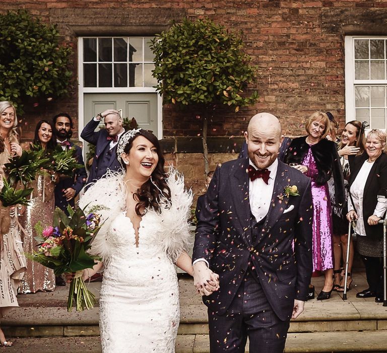 Confetti Moment with Bride in Martina Liana Wedding Dress &amp; Ostrich Feather Cover-up and  Groom in Tom Ford Suit