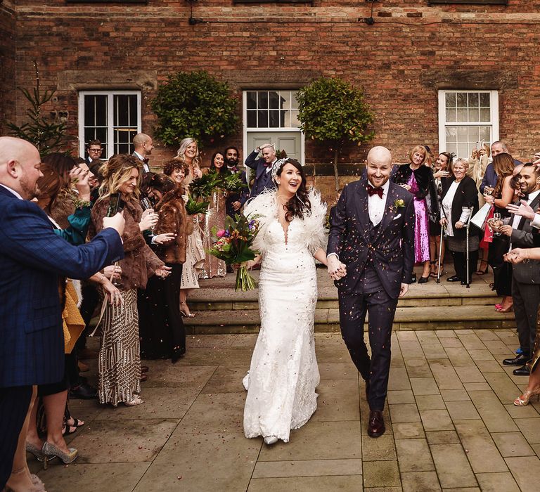 Confetti Moment with Bride in Martina Liana Wedding Dress &amp; Ostrich Feather Cover-up and  Groom in Tom Ford Suit