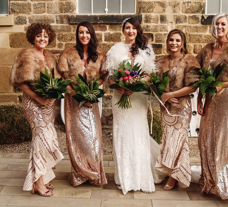 Bridal Party with Bridesmaids in Gold Sequin Dresses and Faux Fur Cover Ups and Bride in Martina Liana Wedding Dress &amp; Ostrich Feather Cover-up