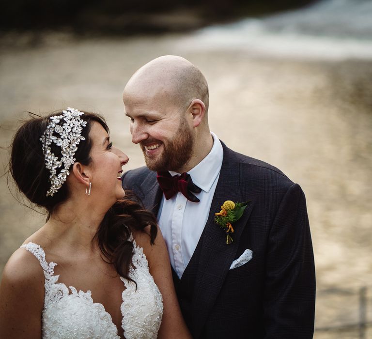 Bride in Martina Liana Wedding Dress &amp; Ostrich Feather Cover-up and Groom in Tom Ford Suit Embracing