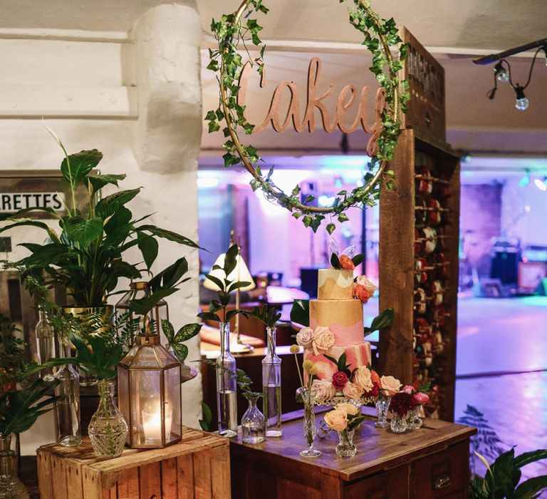 Wedding Cake Display on Vintage Drawers with Wooden Crates , Candles and Tropical Plant Decor