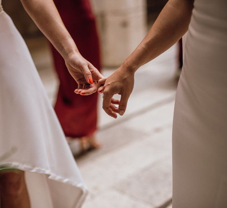 Red wedding nails for bride in high low wedding dress