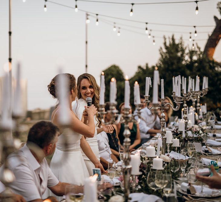 Brides enjoy outdoor wedding breakfast