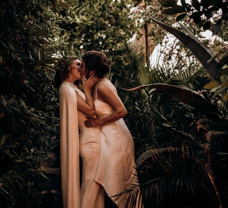 Brides kiss at destination wedding