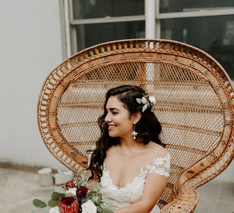 Bride wearing beautiful bridal separates with king protea wedding bouquet