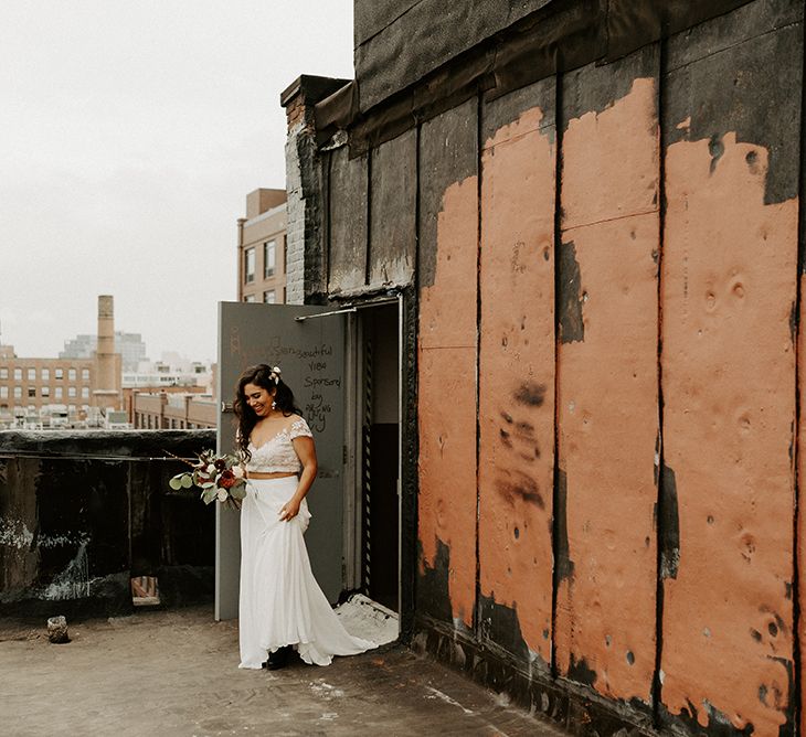 Bride walking to a first look with her groom wearing bridal separates for Brooklyn elopement