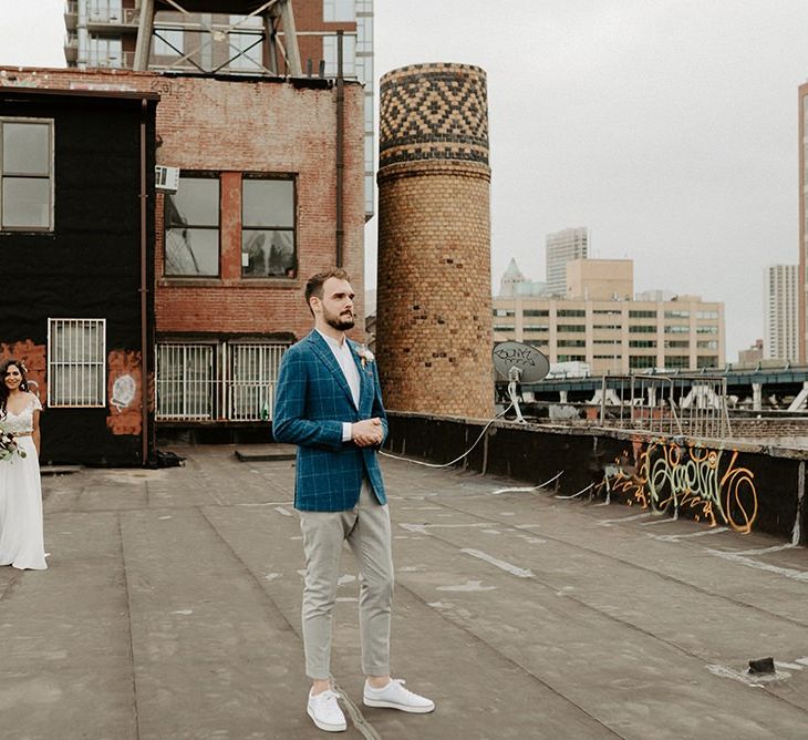 Bride and Groom first look moment on rooftop building with Manhattan skyline for Brooklyn elopement