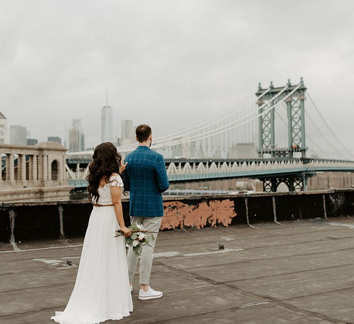 Bride and Groom first look moment on rooftop building with Manhattan skyline for Brooklyn elopement